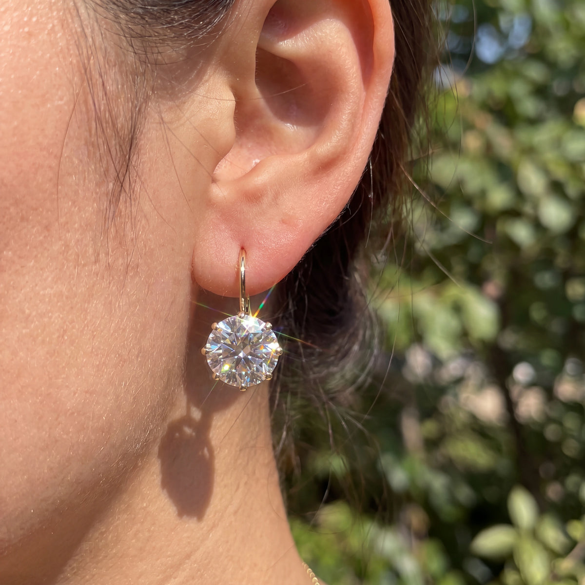 A Classic Solitaire Drop with a Leverback Closure — natural wearing view