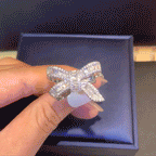 Moissanite bow ribbon ring shown in motion
