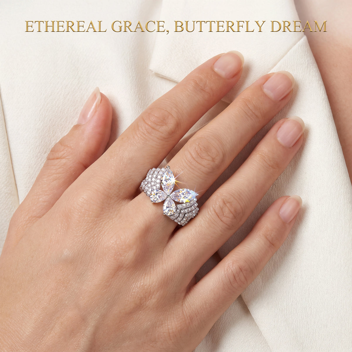 Butterfly ring styled against ivory fabric