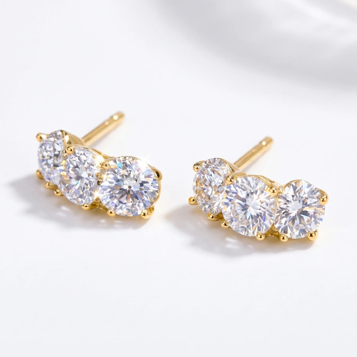 Gold-tone three-stone curved stud earrings