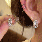 Three-stone curved studs shown in motion