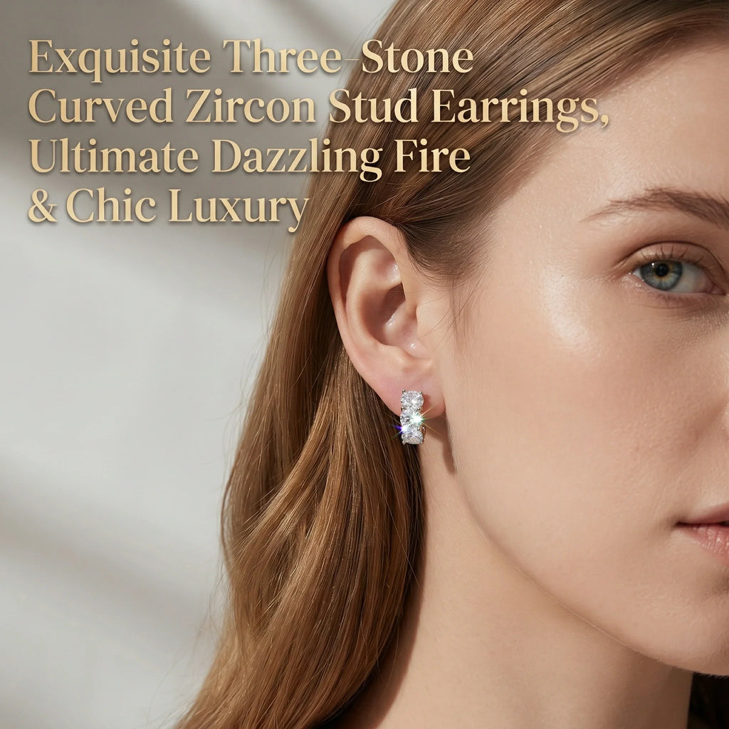 Three-stone curved stud earrings worn on the ear