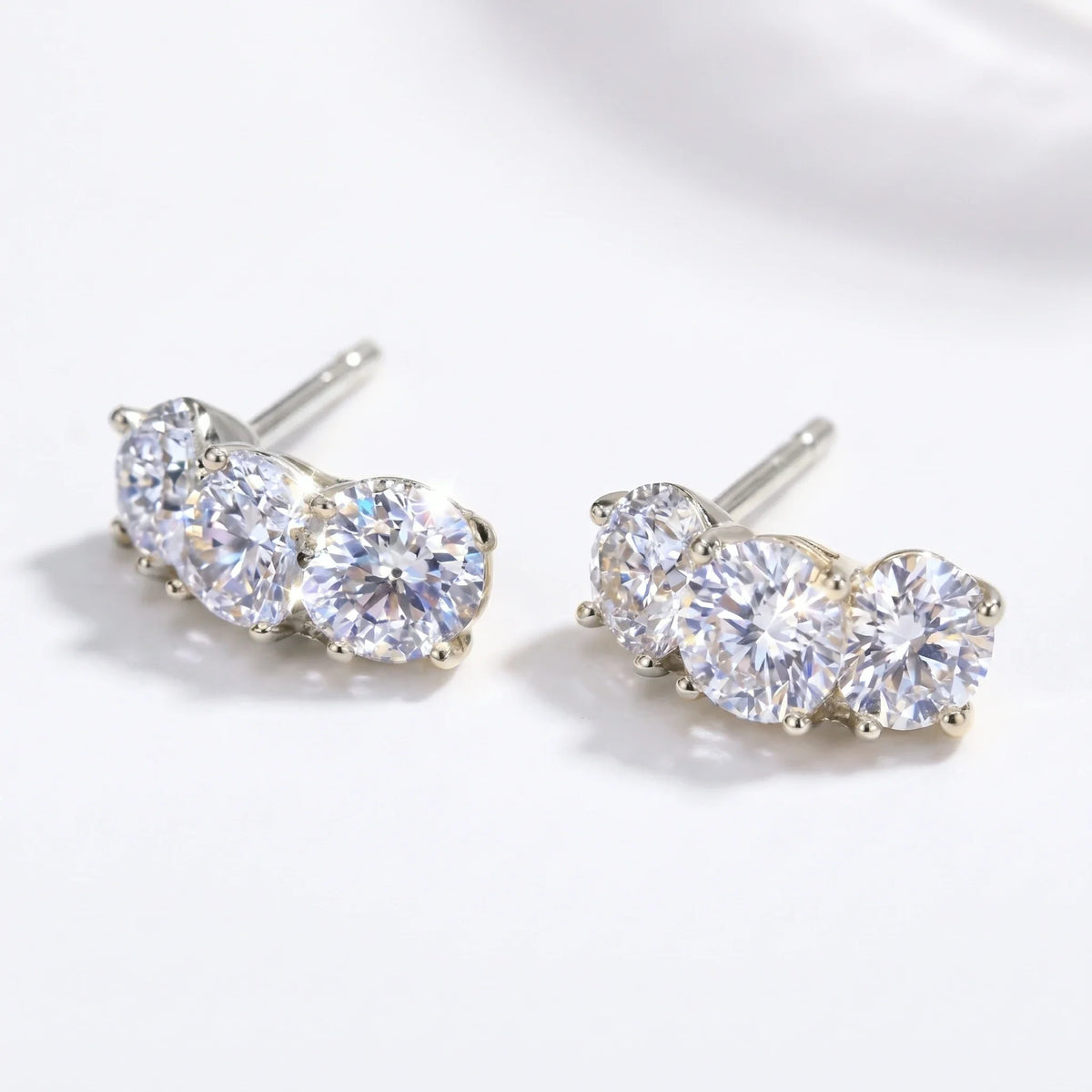 Silver-tone three-stone curved stud earrings