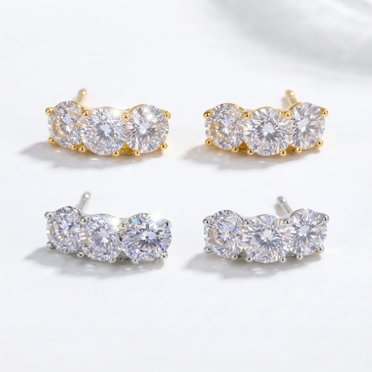 Gold-tone and silver-tone pairs of three-stone studs